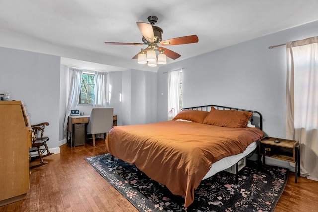 bedroom with hardwood / wood-style floors and ceiling fan