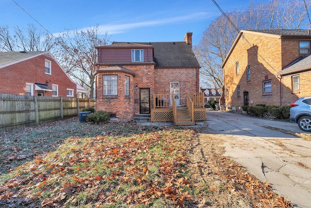 back of house with central AC unit