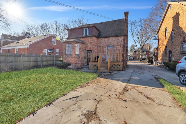 rear view of house with a yard