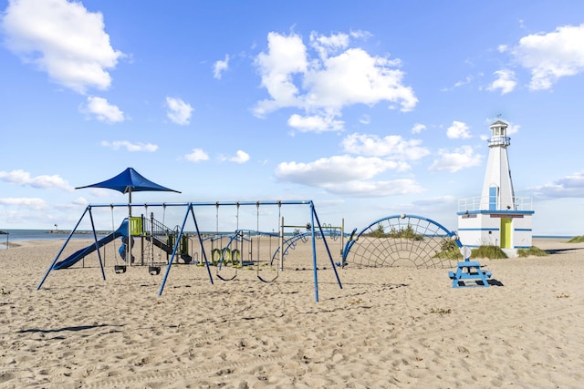 view of play area featuring a beach view and a water view