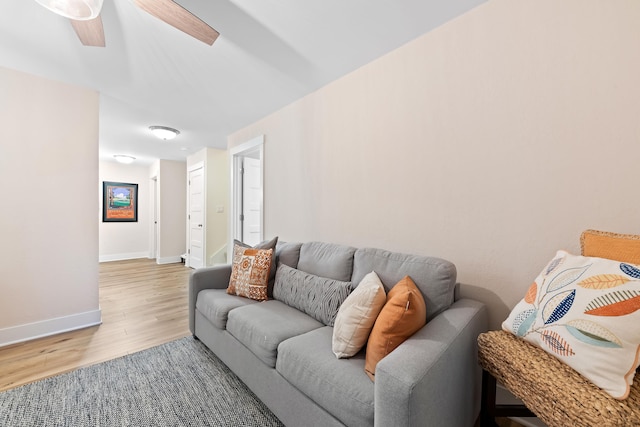 living room featuring ceiling fan and light wood-type flooring