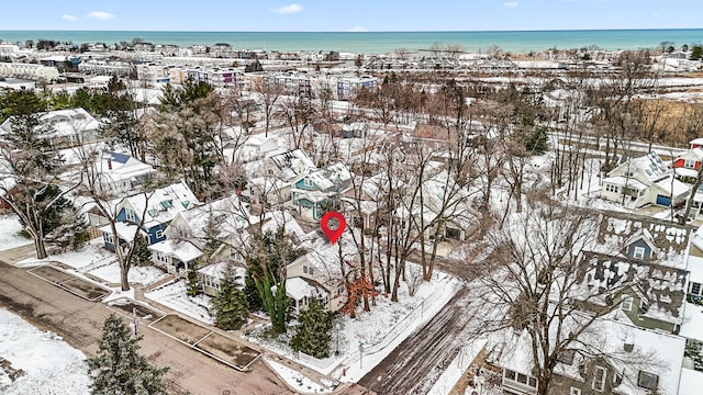 snowy aerial view with a water view