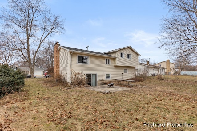 back of house with a yard and a patio area