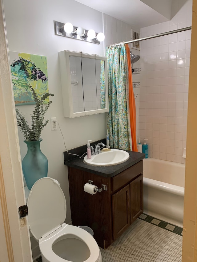 full bathroom featuring tile patterned flooring, vanity, shower / tub combo, and toilet