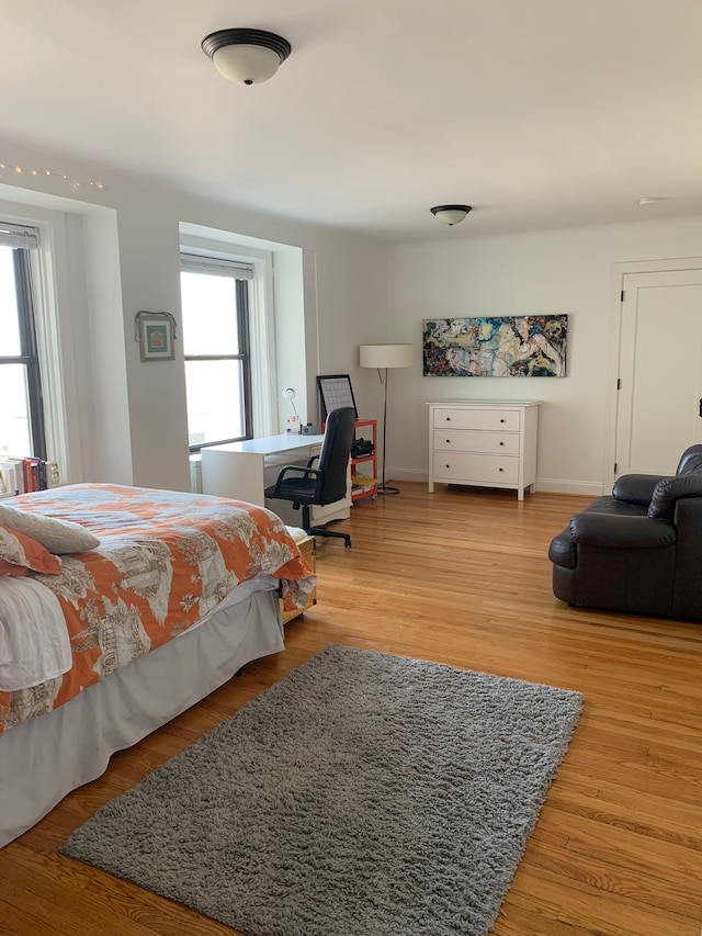 bedroom featuring light wood-type flooring and multiple windows