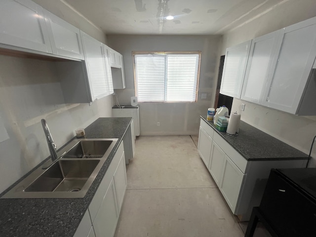 kitchen with white cabinetry and sink