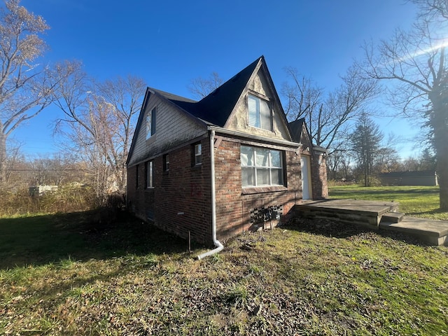 view of side of home with a lawn