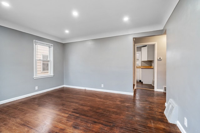 spare room with dark wood-type flooring