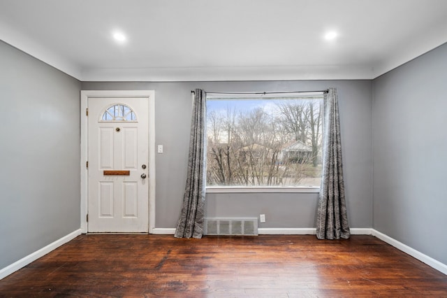 foyer with a healthy amount of sunlight and dark hardwood / wood-style floors