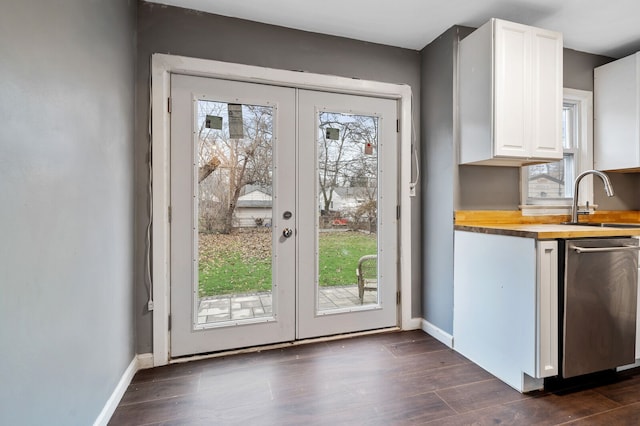 doorway with dark hardwood / wood-style floors, sink, and french doors