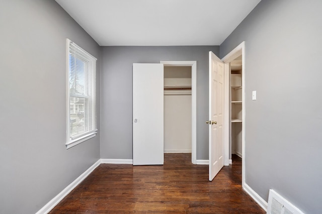 unfurnished bedroom featuring dark wood-type flooring