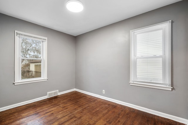 spare room with dark hardwood / wood-style floors