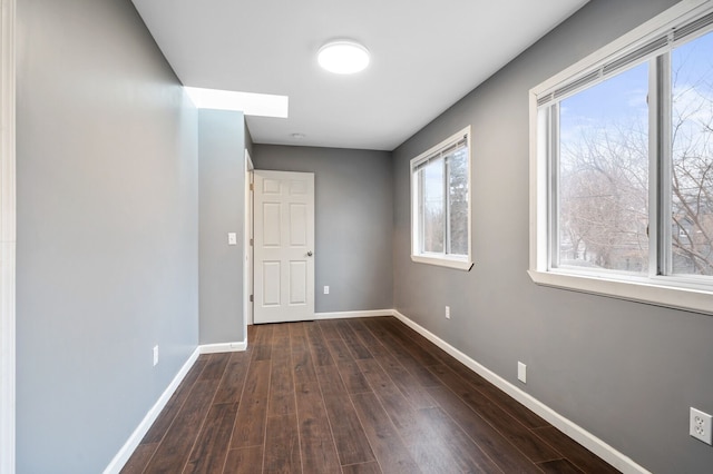 spare room featuring dark wood-type flooring