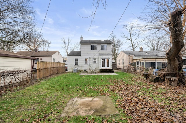 back of house featuring central air condition unit, a yard, and a patio