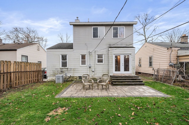 back of house with a lawn, central AC, a patio, and french doors