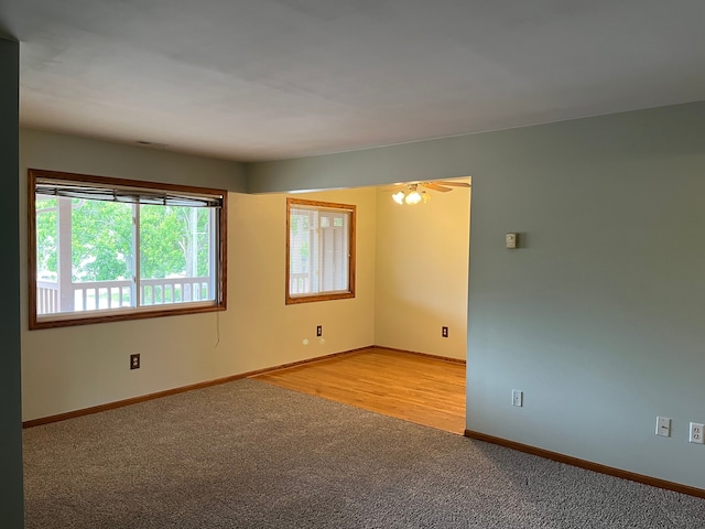 spare room with light colored carpet and ceiling fan