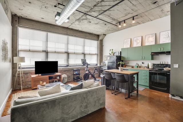 living room with concrete floors and track lighting