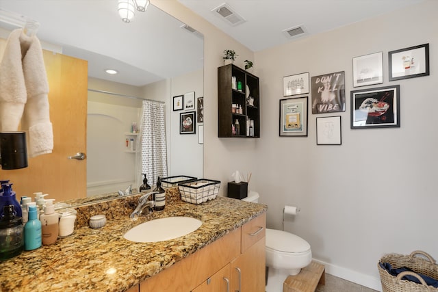 bathroom featuring tile patterned flooring, a shower with curtain, vanity, and toilet