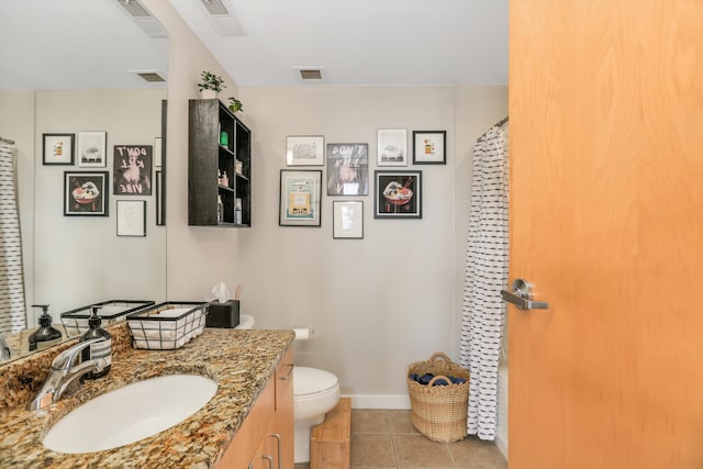 bathroom featuring tile patterned floors, vanity, and toilet