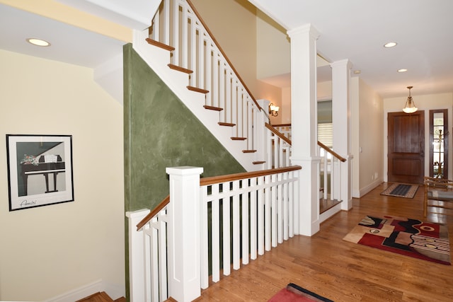 entrance foyer featuring recessed lighting, decorative columns, baseboards, and wood finished floors