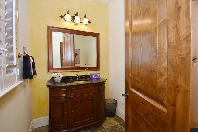 bathroom with vanity and baseboards