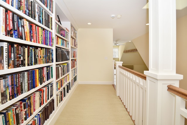 corridor with recessed lighting, light carpet, and an upstairs landing