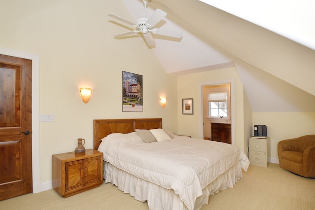 bedroom with light carpet, ensuite bath, baseboards, and vaulted ceiling