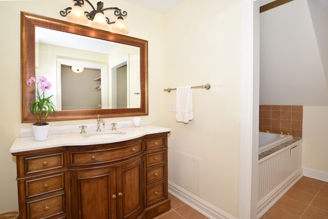 bathroom with a bathtub, tile patterned flooring, vanity, and baseboards