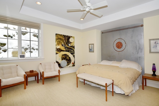 bedroom featuring carpet, a tray ceiling, ceiling fan, and recessed lighting