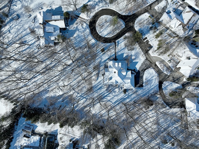 snowy aerial view with a residential view