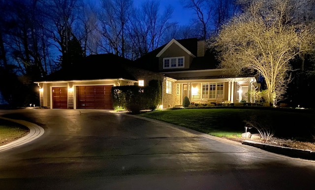 craftsman-style house featuring a garage, concrete driveway, and a lawn