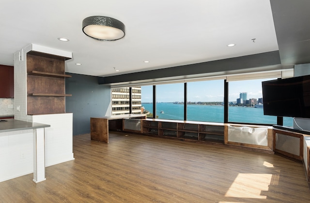 unfurnished living room featuring hardwood / wood-style flooring