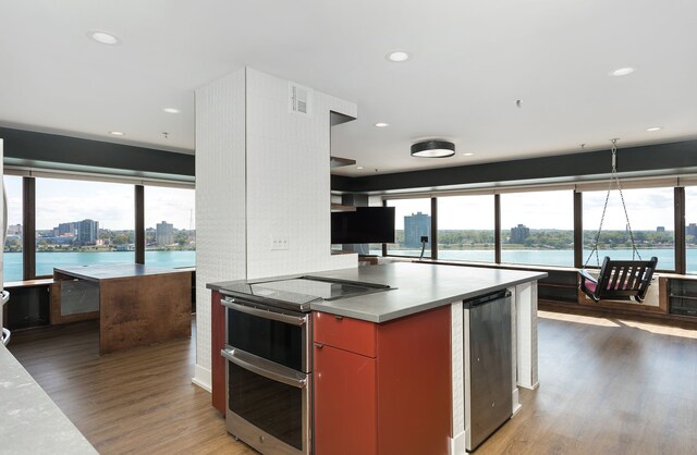 kitchen featuring backsplash, stainless steel electric range, white cabinetry, and dark wood-type flooring