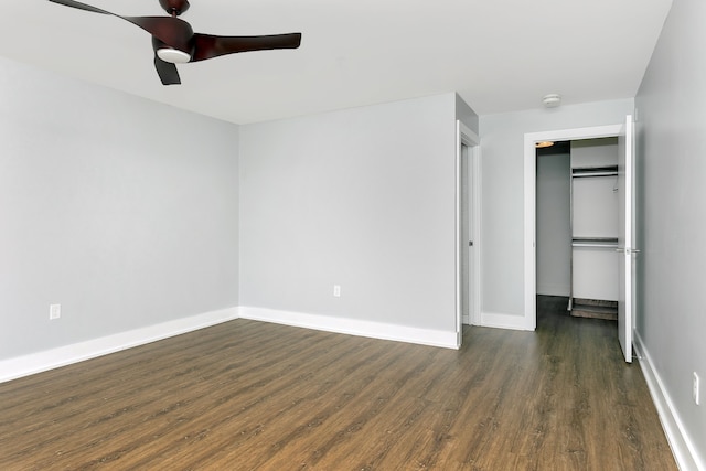 unfurnished bedroom with a closet, ceiling fan, and dark wood-type flooring