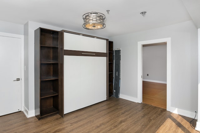 unfurnished bedroom with dark hardwood / wood-style floors