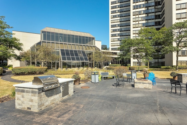 surrounding community featuring an outdoor kitchen and a patio