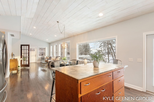 kitchen with stainless steel refrigerator, pendant lighting, a kitchen island, and wooden ceiling