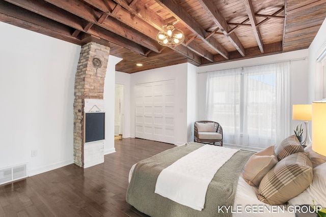 bedroom with beam ceiling, dark hardwood / wood-style flooring, wooden ceiling, and a notable chandelier