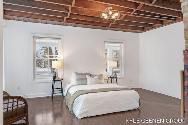 bedroom featuring beam ceiling and dark wood-type flooring