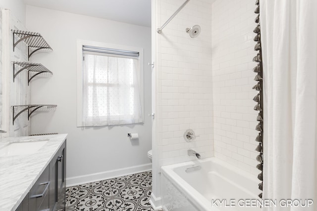 full bathroom with vanity, tile patterned floors, tiled shower / bath combo, and toilet