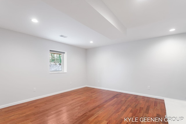 unfurnished room with hardwood / wood-style flooring