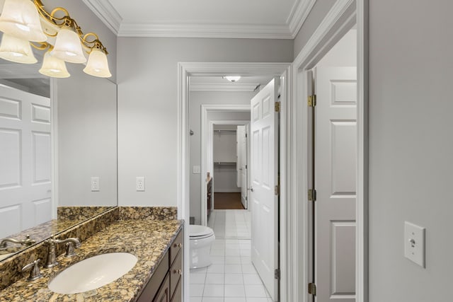 bathroom with tile patterned flooring, vanity, toilet, and ornamental molding