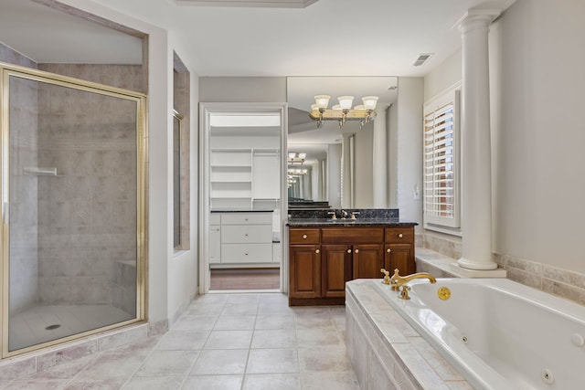 bathroom with decorative columns, tile patterned flooring, vanity, and shower with separate bathtub