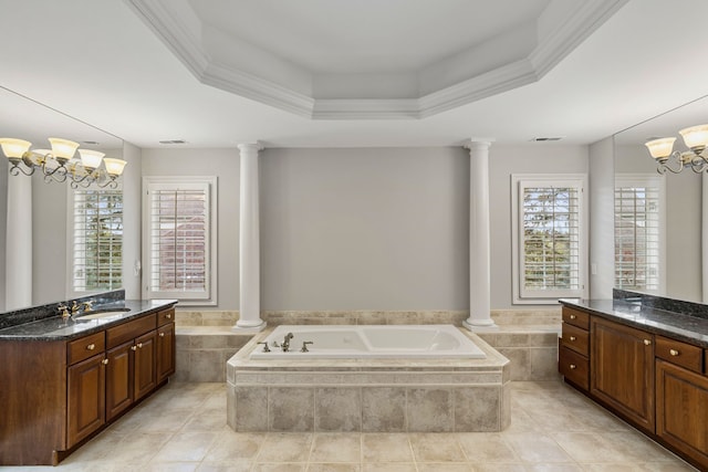 bathroom with vanity, ornate columns, a tray ceiling, and an inviting chandelier