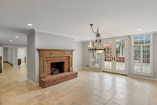 living room with an inviting chandelier, ornamental molding, a fireplace, and french doors