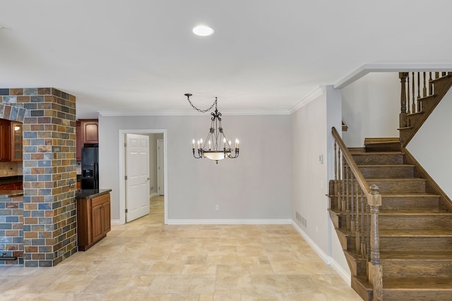 interior space with an inviting chandelier and ornamental molding