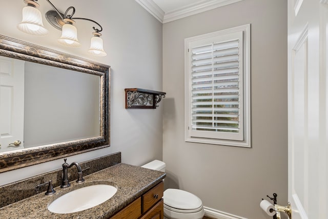 bathroom with vanity, toilet, and crown molding