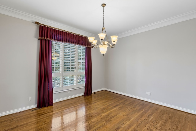 unfurnished room with hardwood / wood-style floors, crown molding, and an inviting chandelier