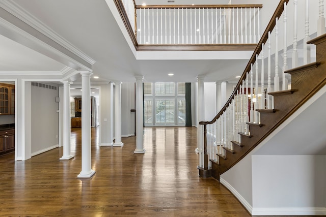 foyer entrance featuring hardwood / wood-style flooring and ornamental molding