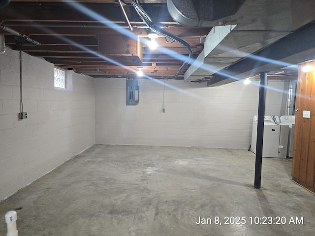 basement featuring electric panel and washing machine and dryer